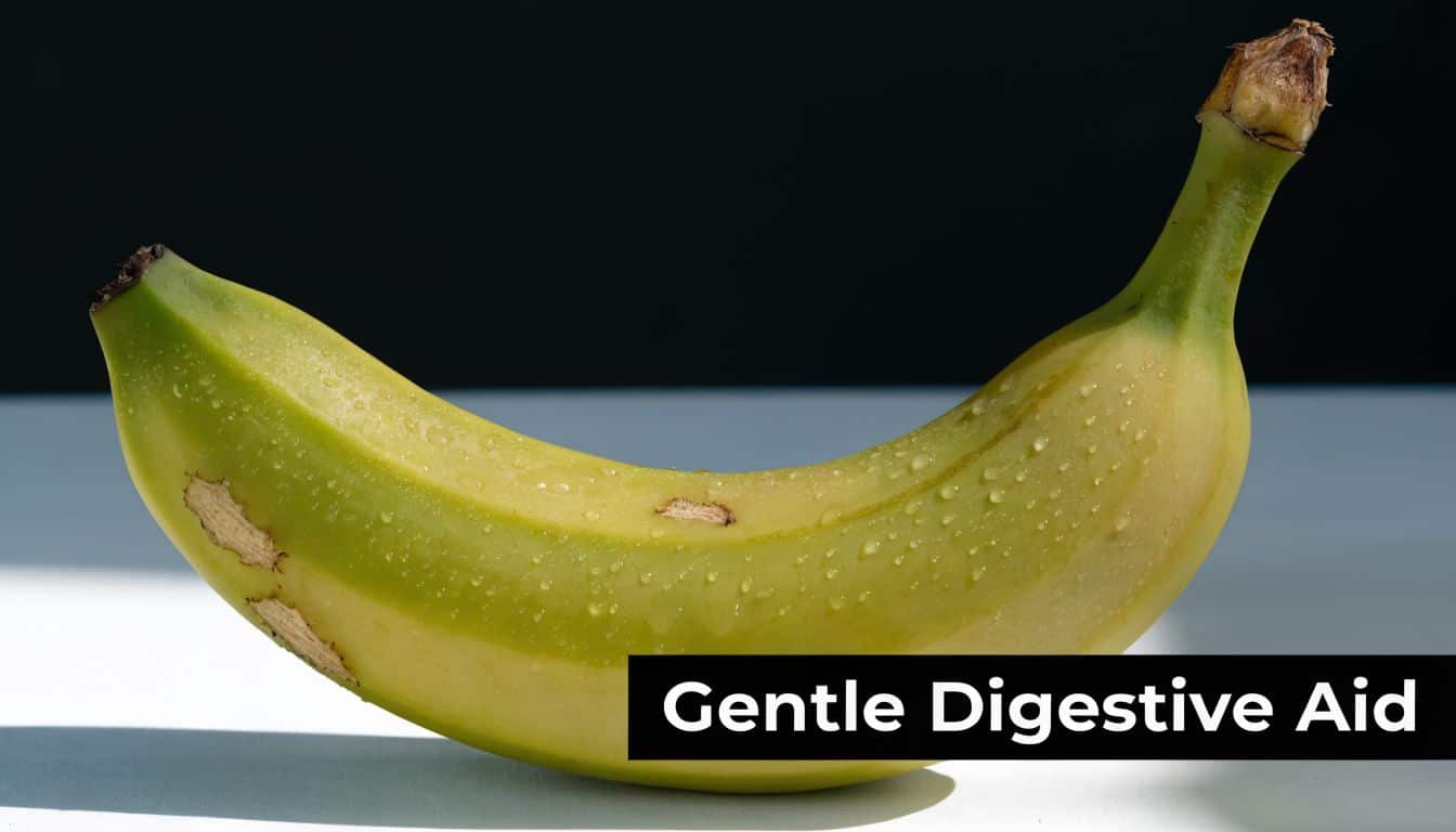 A slightly green, damp banana resting on a white surface with the text Gentle Digestive Aid.