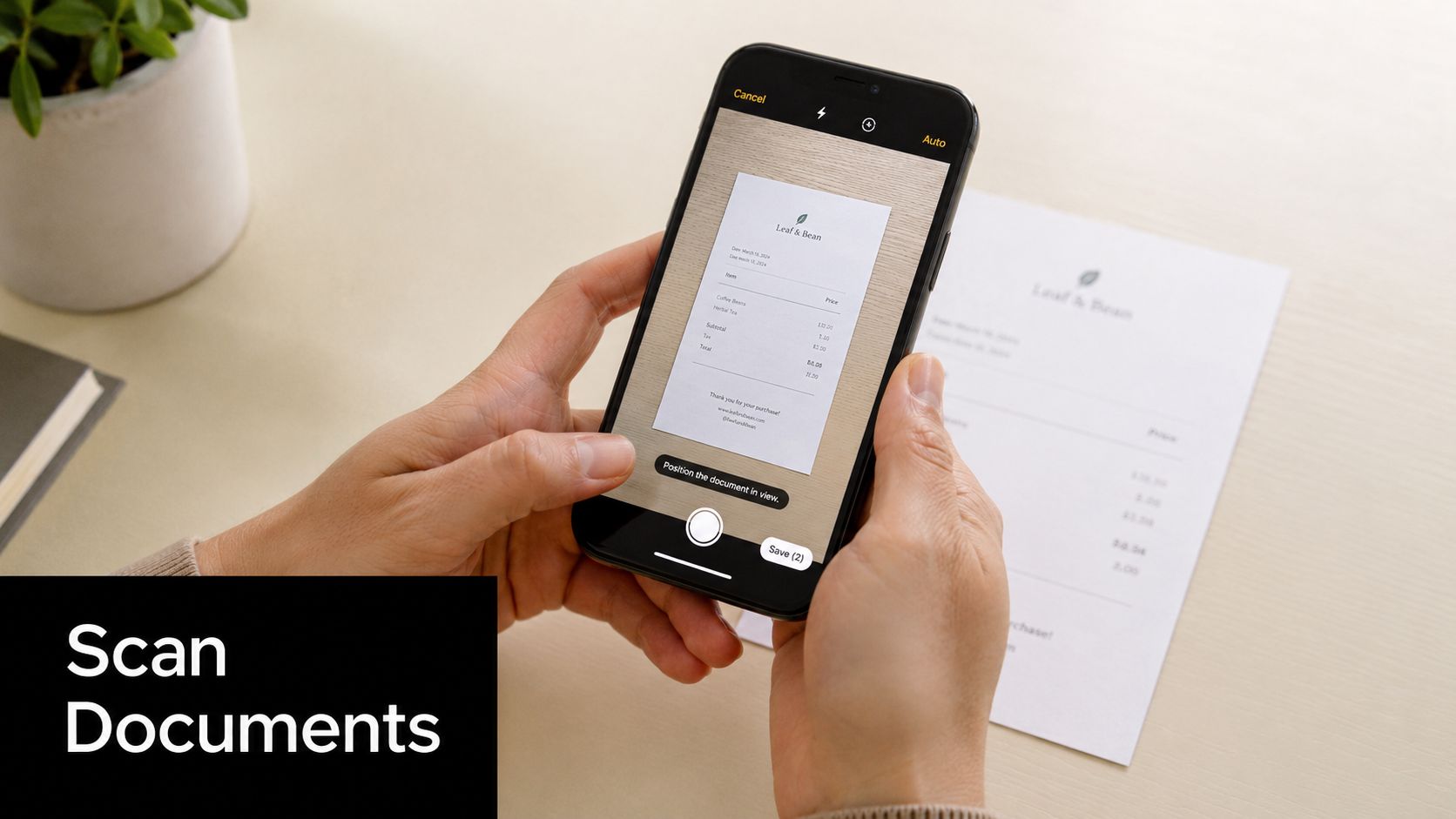 A person's hands holding an iPhone to scan a Leaf & Bean receipt document.
