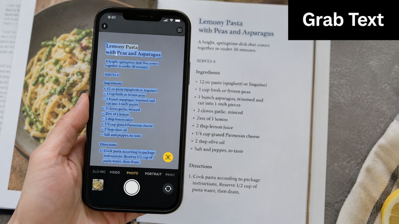 A person holding an iPhone scanning a pasta recipe from a cookbook using live text technology.