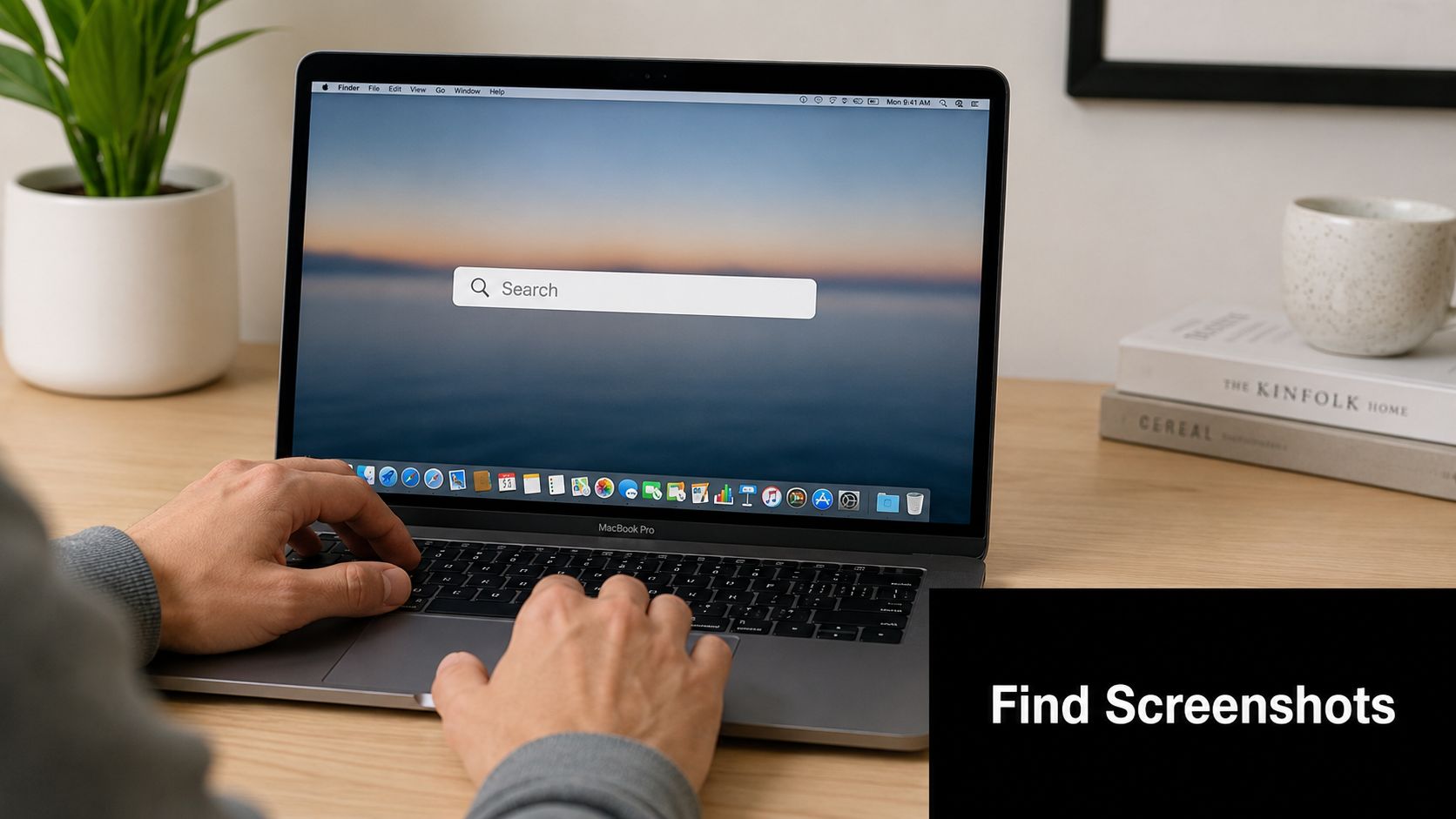 A person using a MacBook Pro to search for files in a bright home office setting.